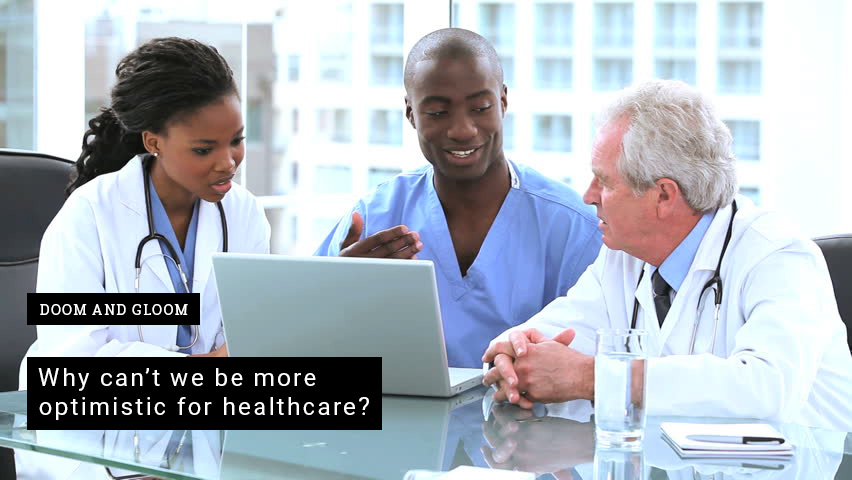 Doctors talking around a laptop
